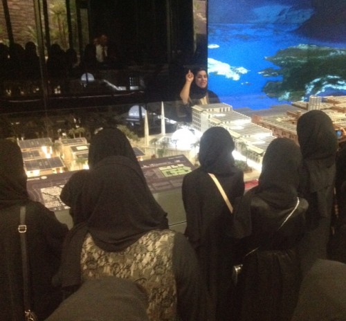 Shaima showing the students the model of Masdar